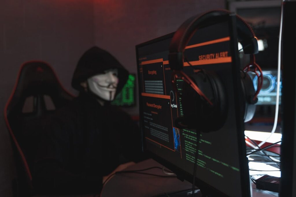 Person in Black Hoodie Hacking a Computer System